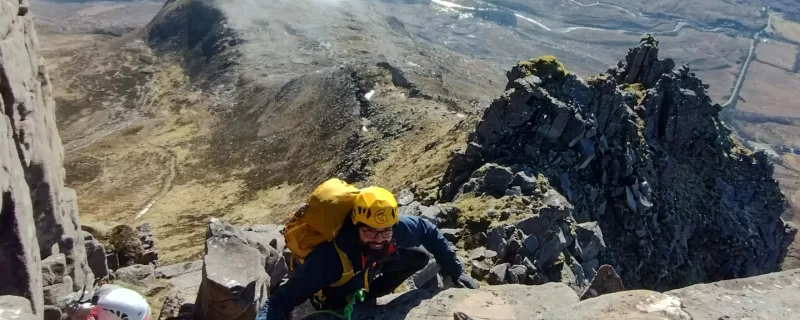 Two advanced scramblers with pinnacles in the background