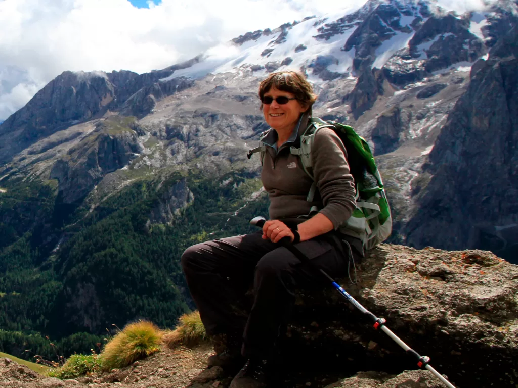 Photo of Sue sat with mountains in the background