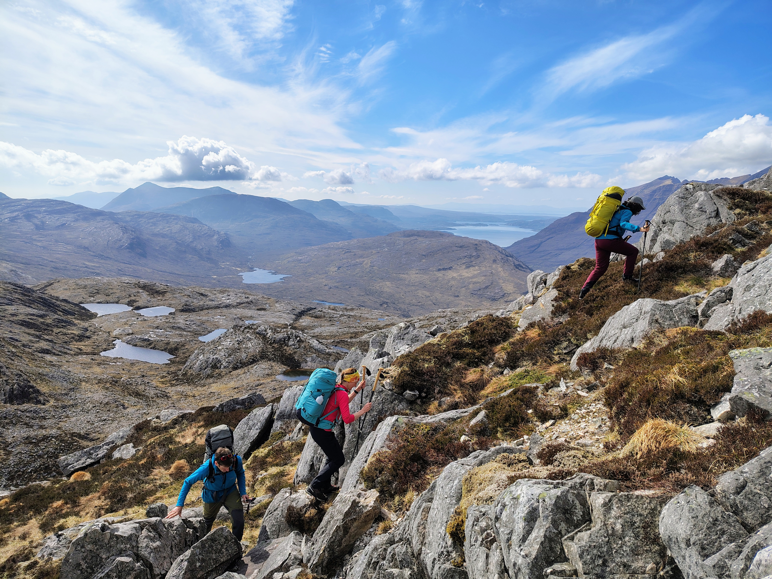 Photo of a group working their way through complex mountain terrain.