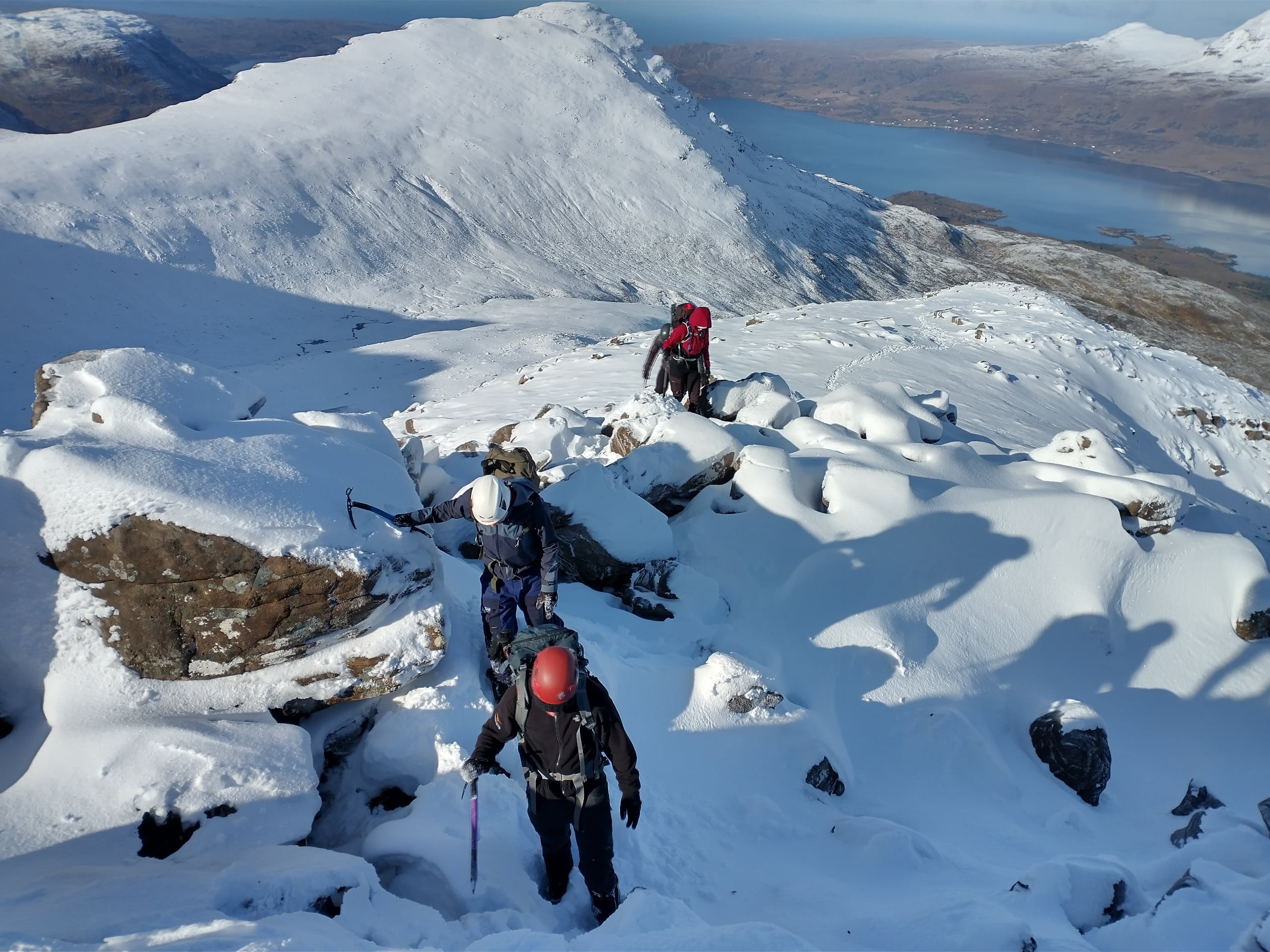 Climbers ascend towards Beinn Damph