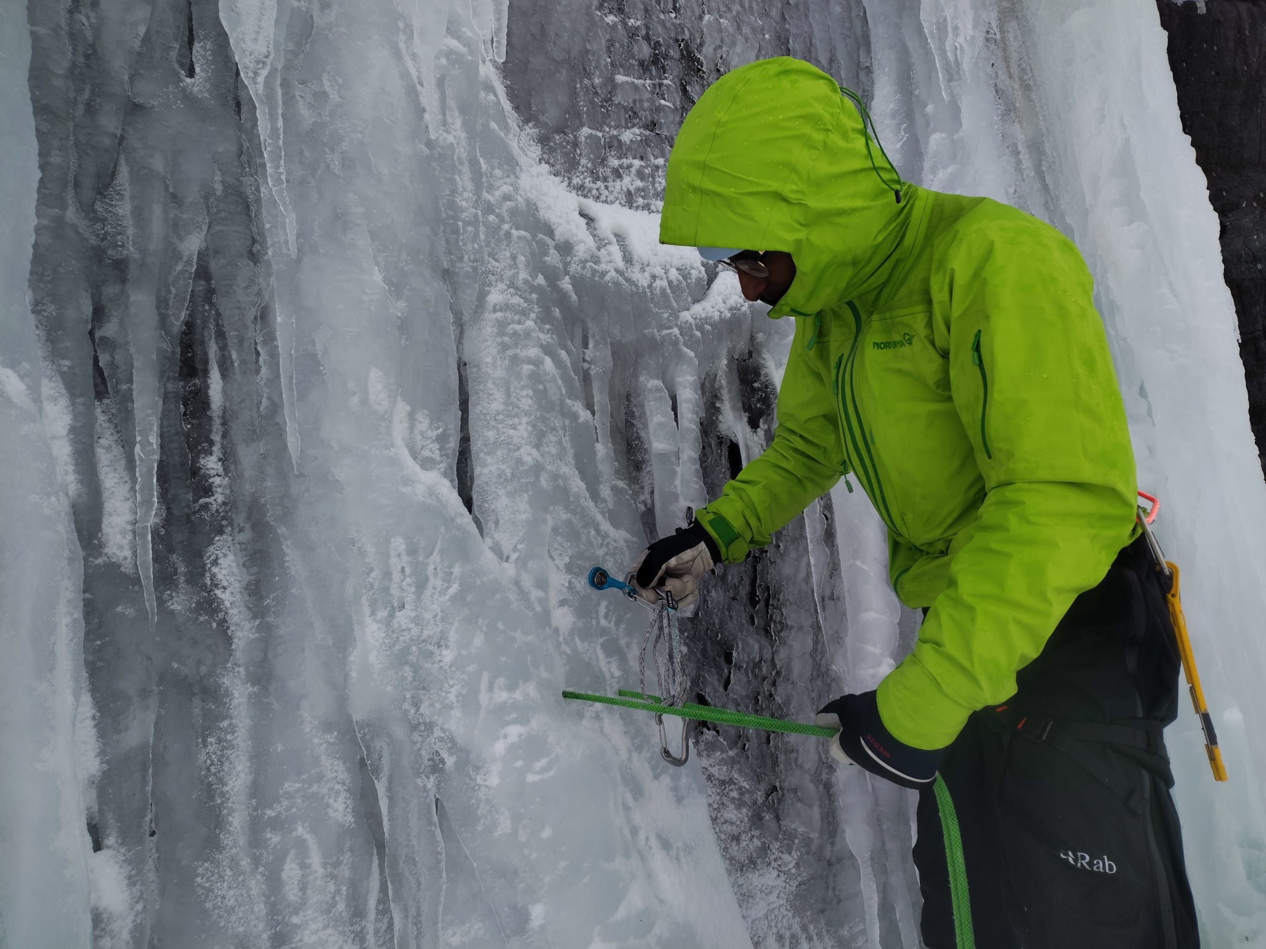 client placing ice screw and creating a thread.